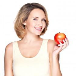 Portrait of a young smiling healthy woman with apple